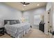 Carpeted bedroom with gray walls, two windows, and a ceiling fan at 135 Frostcliff Ln, Mooresville, NC 28117
