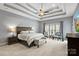 Spacious main bedroom with a decorative ceiling, ceiling fan, and sitting area at 135 Frostcliff Ln, Mooresville, NC 28117