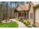 Landscaped walkway leading to the front door of this home with stacked stone and timber accents at 135 Frostcliff Ln, Mooresville, NC 28117