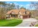 Well-manicured lawn and long driveway of this home, with a view of the attached two car garage at 135 Frostcliff Ln, Mooresville, NC 28117