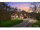 Well-manicured lawn and long driveway of this home, with a view of the attached two car garage at 135 Frostcliff Ln, Mooresville, NC 28117