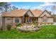 Charming single Gathering home featuring manicured landscaping, stone accents and a welcoming front porch at 135 Frostcliff Ln, Mooresville, NC 28117