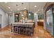 Spacious kitchen features granite counters, wood floors, green cabinets, and a stone range hood at 135 Frostcliff Ln, Mooresville, NC 28117