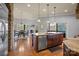 Open kitchen with granite counters and stainless steel dishwasher overlooking dining area and wooded lot at 135 Frostcliff Ln, Mooresville, NC 28117
