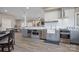 Kitchen and dining area with stainless steel appliances and gray cabinets at 135 Frostcliff Ln, Mooresville, NC 28117