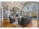 Spacious living room with a vaulted ceiling, large stone fireplace, and built-in shelving at 135 Frostcliff Ln, Mooresville, NC 28117