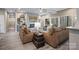 Living room features a modern fireplace, large windows and a flat screen tv at 135 Frostcliff Ln, Mooresville, NC 28117