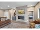 Comfortable living room with a fireplace, shelving, tv, and access to other parts of the house at 135 Frostcliff Ln, Mooresville, NC 28117