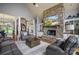 Open living room featuring a stone fireplace and hardwood floors at 135 Frostcliff Ln, Mooresville, NC 28117