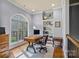 Bright office with hardwood floors and a large window overlooking the trees at 135 Frostcliff Ln, Mooresville, NC 28117