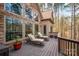 Outdoor deck with two lounge chairs next to a wall of windows and stone at 135 Frostcliff Ln, Mooresville, NC 28117