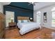 Spacious bedroom features hardwood floors, a ceiling fan, and large windows for natural light at 15327 Rush Lake Ln, Huntersville, NC 28078