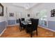 Bright dining room with large windows, modern lighting, and stylish decor, perfect for Gathering meals at 15327 Rush Lake Ln, Huntersville, NC 28078