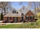Charming brick home with manicured lawn, black shutters, arched windows, and a welcoming front entrance at 15327 Rush Lake Ln, Huntersville, NC 28078