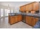 A kitchen with wooden cabinets, stainless steel appliances, and granite countertops at 15327 Rush Lake Ln, Huntersville, NC 28078