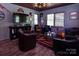 Inviting living room with ample seating, wood floors, and a custom ceiling design at 15327 Rush Lake Ln, Huntersville, NC 28078