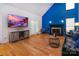Stylish living room with fireplace, entertainment center, and french doors, perfect for relaxing or gatherings at 15327 Rush Lake Ln, Huntersville, NC 28078