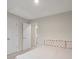 This bedroom has neutral walls and carpet with access to a bathroom through an open door at 19412 Bird Meadow Dr, Huntersville, NC 28078