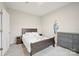 Neutral bedroom with a dark wood bed frame and gray dresser at 19412 Bird Meadow Dr, Huntersville, NC 28078
