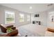 Spacious bonus room with plush carpeting, plenty of light, and two leather chairs at 19412 Bird Meadow Dr, Huntersville, NC 28078