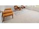Bonus room featuring neutral carpeting, rug, a brown bench, and two leather chairs at 19412 Bird Meadow Dr, Huntersville, NC 28078