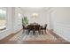 Elegant dining room features modern chandelier, large windows, and seating for six at 19412 Bird Meadow Dr, Huntersville, NC 28078