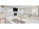 Modern kitchen with stainless steel sink, quartz countertops, and a clear view to the living room at 19412 Bird Meadow Dr, Huntersville, NC 28078