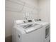 Bright laundry room features new, white, front load washer and dryer at 19412 Bird Meadow Dr, Huntersville, NC 28078