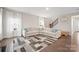 Cozy living area featuring a neutral sectional sofa and decorative rug at 19412 Bird Meadow Dr, Huntersville, NC 28078
