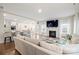 Open-concept living room with a fireplace that flows into the kitchen and dining area at 19412 Bird Meadow Dr, Huntersville, NC 28078