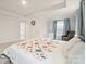 Main bedroom with a tray ceiling, soft blue accents, and a large bed at 19412 Bird Meadow Dr, Huntersville, NC 28078