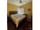 Cozy bedroom with a ceiling fan, wooden furniture, and a decorative quilt on the bed at 201 Fancy Lady Ct, York, SC 29745