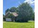 Traditional brick home with an attached garage, manicured lawn, and mature trees providing shade at 201 Fancy Lady Ct, York, SC 29745