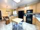 Well-equipped kitchen with wooden cabinets, black appliances, and a practical butcher block island at 201 Fancy Lady Ct, York, SC 29745