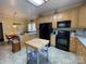 Traditional kitchen with light wood cabinets, black appliances, and functional island at 201 Fancy Lady Ct, York, SC 29745