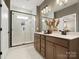 Modern bathroom features a large glass enclosed shower, dual sink vanity, and elegant neutral finishes at 2018 Puddle Pond Rd, Indian Trail, NC 28079