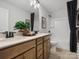 Well-lit bathroom with double vanity, modern fixtures, and a shower-tub combination at 2018 Puddle Pond Rd, Indian Trail, NC 28079
