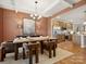 Charming dining area featuring stylish wood table, modern chandelier, and seamless flow to the kitchen at 2018 Puddle Pond Rd, Indian Trail, NC 28079