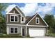 Inviting two-story home showcasing a white garage door, neutral siding, and a tastefully landscaped front yard at 2018 Puddle Pond Rd, Indian Trail, NC 28079