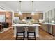 Spacious eat-in kitchen with stainless steel appliances, kitchen island, and a seamless connection to the dining area at 2018 Puddle Pond Rd, Indian Trail, NC 28079
