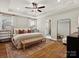 Serene primary bedroom features a tray ceiling, ample natural light, and a view into the en-suite bathroom at 2018 Puddle Pond Rd, Indian Trail, NC 28079