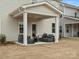Cozy covered patio with stylish outdoor furniture, perfect for relaxation at 2018 Puddle Pond Rd, Indian Trail, NC 28079
