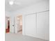 Bedroom showcasing access to the bathroom, multiple closets, and neutral carpeting at 2208 Bay St, Charlotte, NC 28205
