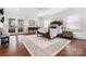 Spacious bedroom with a large rug, double doors to the backyard, and hardwood floors at 2208 Bay St, Charlotte, NC 28205