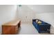 Finished attic bonus room with a desk, blue couch and plenty of light at 2208 Bay St, Charlotte, NC 28205