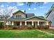 Charming two-story home with a welcoming front porch and beautiful landscaping at 2208 Bay St, Charlotte, NC 28205
