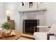 Close-up of a stylish fireplace with a painted brick surround in a living room setting at 2208 Bay St, Charlotte, NC 28205