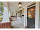 Covered porch features hanging lanterns, brick accents, and an inviting front entrance at 2208 Bay St, Charlotte, NC 28205