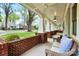 Spacious front porch with brick accents, white columns, and comfortable seating area at 2208 Bay St, Charlotte, NC 28205