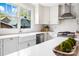Bright kitchen features a farmhouse sink, stainless steel appliances, and white cabinets at 2208 Bay St, Charlotte, NC 28205